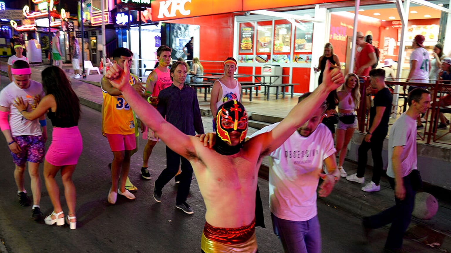 Is the party over? Young tourists walk on the street at in Magaluf on the Spanish Balearic island of Mallorca, Spain