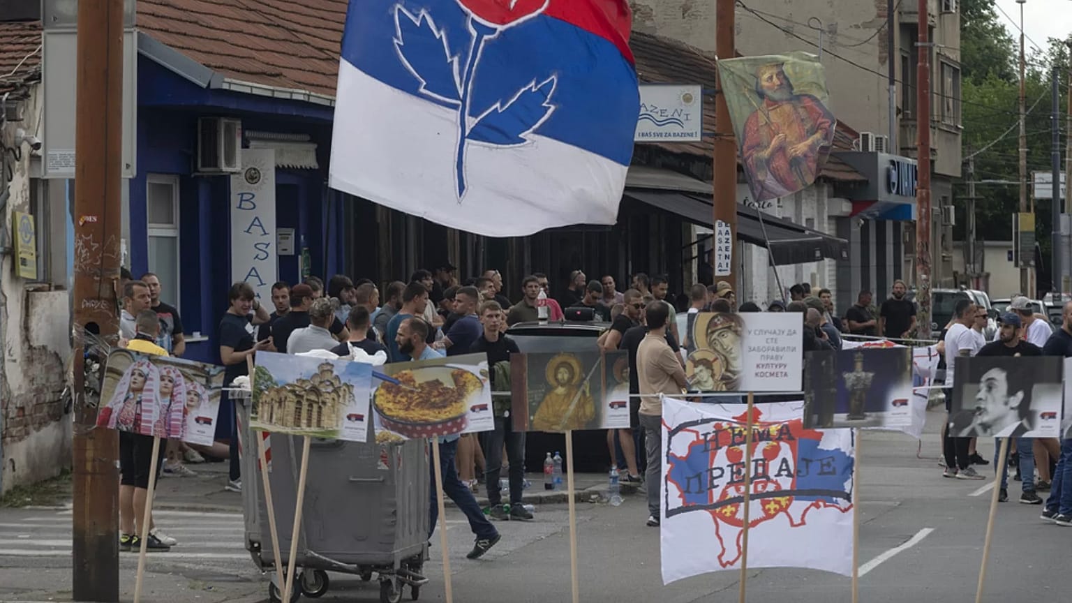 Bir kişi, Kosova'nın Mitrovica kentindeki köprüdeki barikatın bir parçası olan yanmış bir kamyonun fotoğraflarını çekiyor, 29 Aralık 2022.
