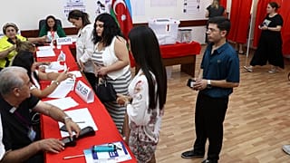 Voters lineup to collect their ballots at a polling station during a snap election in the Milli Mejlis parliament in Baku, Azerbaijan, Sunday, Sept. 1, 2024.