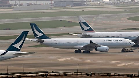In this March 26, 2019 photo, Cathay Pacific Airways passenger aircrafts are parked at the Hong Kong International Airport. 
