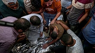 Palestinians mourn a relative killed in the Israeli bombardment of the Gaza Strip at a hospital morgue in Deir al-Balah, Sunday, Sept. 1, 2024.