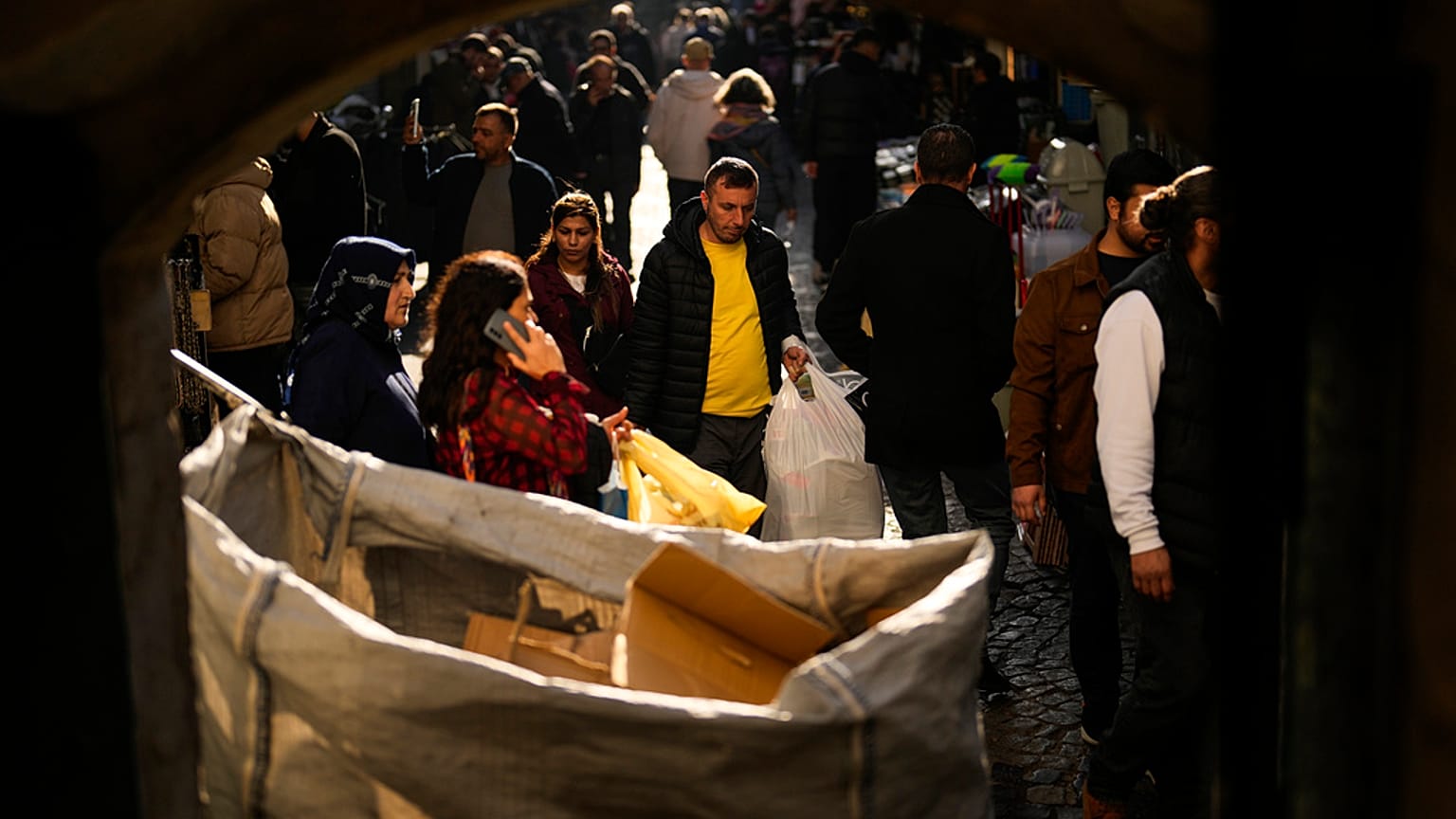 People walk along a street at Eminonu commercial area in Istanbul, Turkey. 7 February 2024.
