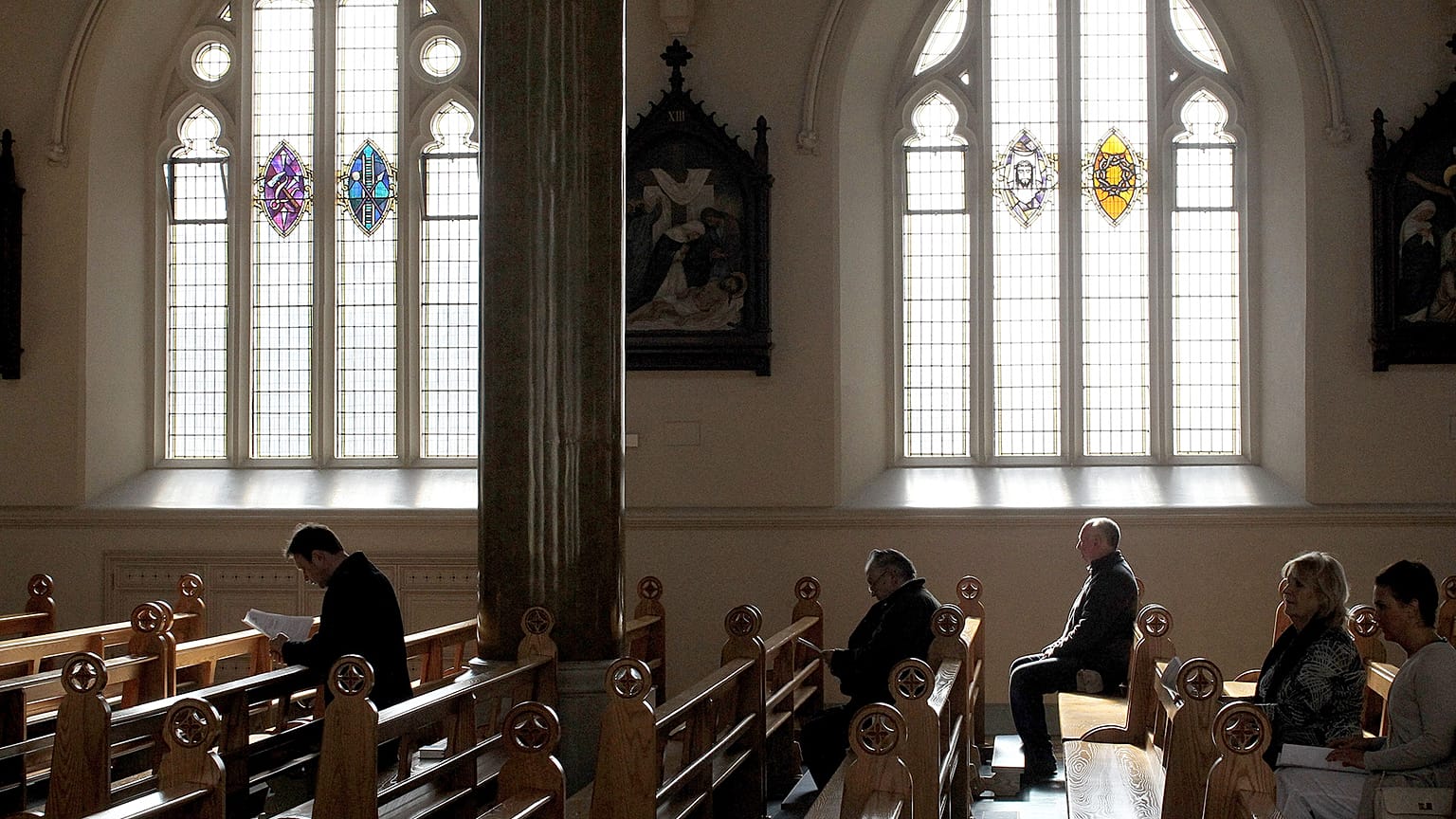 In this March 21, 2010 file phtoo, Roman Catholics listen during mass at St. Peter's Roman Catholic Cathedral, in West Belfast, Northern Ireland.