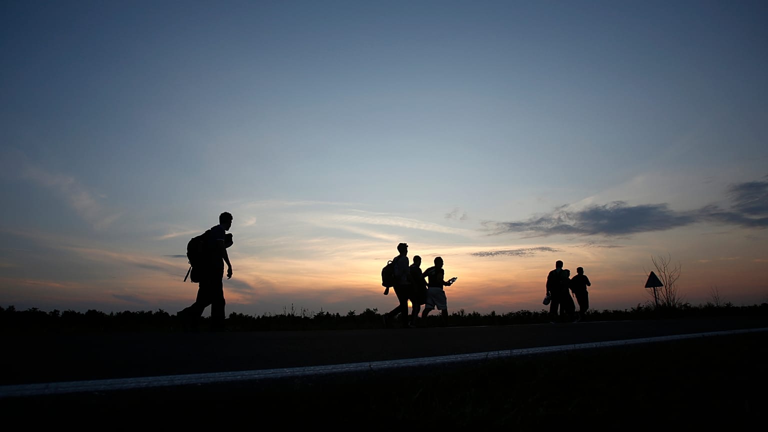 A group of Migrants walking along the road close to the Serbian-Hungarian border near the northern Serbian town of Kanjiza