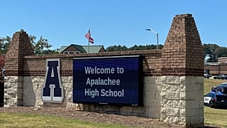 Law enforcement arrive as students are evacuated to the football stadium after the school campus was placed on lockdown at Apalachee High School in Winder, Ga., on Wednesday.