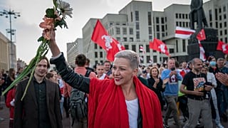 FILE – Opposition organiser Maria Kolesnikova greets protesters at a rally in front of a government building in Independent Square in Minsk, Belarus on Saturday, Aug. 22 2022.