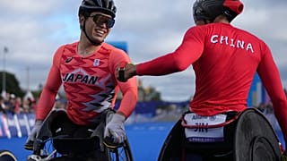Silver medalist China's Hua Jin, right, and bronze medalist Japan's Tomoki Suzuki greet each other after finishing the men's marathon T54 at the 2024 Paralympics, Sunday, Sept