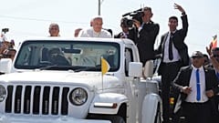 Pope Francis in a car, is welcomed in Dili, East Timor, Monday, Sept. 9, 2024.