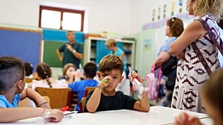 Filippos and other students attend the first day of school at a public elementary school in Athens, on Wednesday, Sept. 11, 2024.