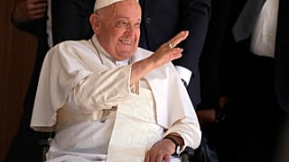 Pope Francis greets people in the Cathedral of the Immaculate Conception