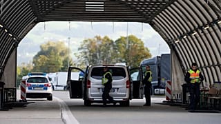 FILE - German federal police officers check a van at the Austrian-German border crossing point in Kiefersfelden, Germany, Oct. 9, 2023.