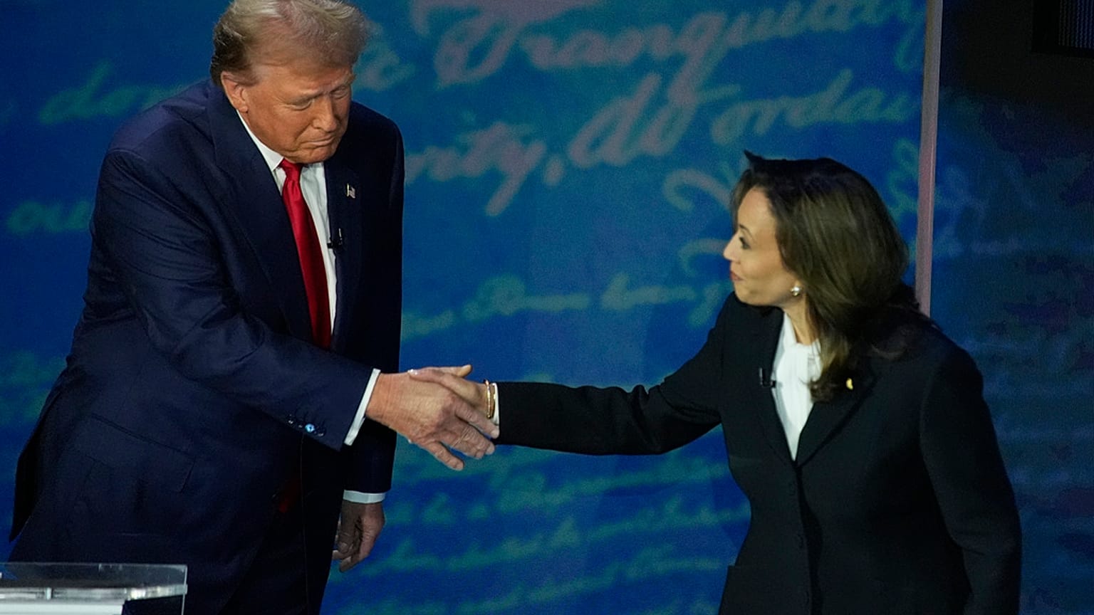 Republican presidential nominee former President Donald Trump shakes hands with Democratic presidential nominee Vice President Kamala Harris 