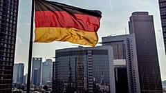 Almanya'nın Frankfurt kentindeki bankacılık bölgesi binalarının önünde bir Alman bayrağı dalgalanıyor