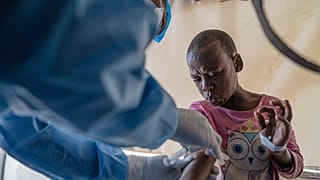 FILE - A health worker attends to an mpox patient, at a treatment center in Munigi, eastern Congo, Aug. 19, 2024.