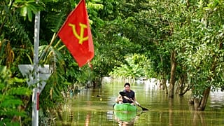 A man paddles a boat in the flood in the aftermath of Typhoon Yagi in An Lac village, Hanoi, Vietnam Friday, Sept. 13, 2024.