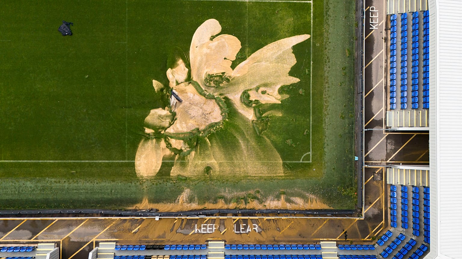  aerial view of a sinkhole on the pitch and flooded walkways at the Cherry Red Records Stadium, home of AFC Wimbledon in London, Monday, Sept. 23, 2024,