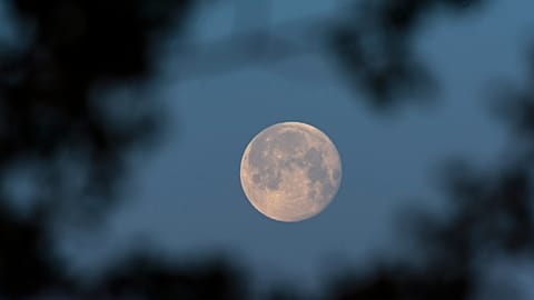 The full moon is seen prior to sunrise above Debrecen, Hungary, Wednesday, April 28, 2021.