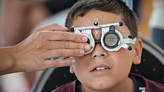 A boy undergoes an eyesight examination performed by volunteer ophthalmologists, in Nucsoara, Romania. 