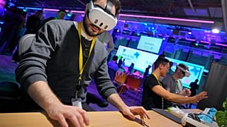 A visitor tries out a Meta Quest 3 headset to for a mixed reality piano playing experience at the Meta AI Day in London, Tuesday, April 9, 2024. 