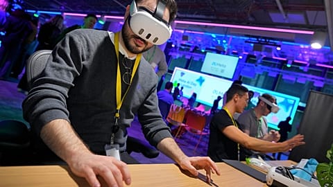 A visitor tries out a Meta Quest 3 headset to for a mixed reality piano playing experience at the Meta AI Day in London, Tuesday, April 9, 2024. 