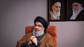 نصرالله در کنر تصاویری از خامنهای و خمینی، رهبران انقلاب اسلامی در ایران