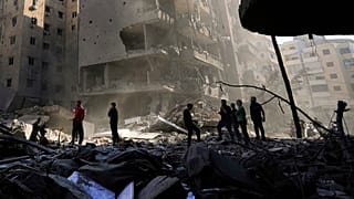 Beyrut'un güney banliyölerinde Hizbullah lideri Hasan Nasrallah'ın öldürüldüğü yeri kontrol eden insanlar, 29 Eylül 2024, Pazar.