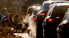 Cars release exhaust fumes as children head to school in Frankfurt, Germany