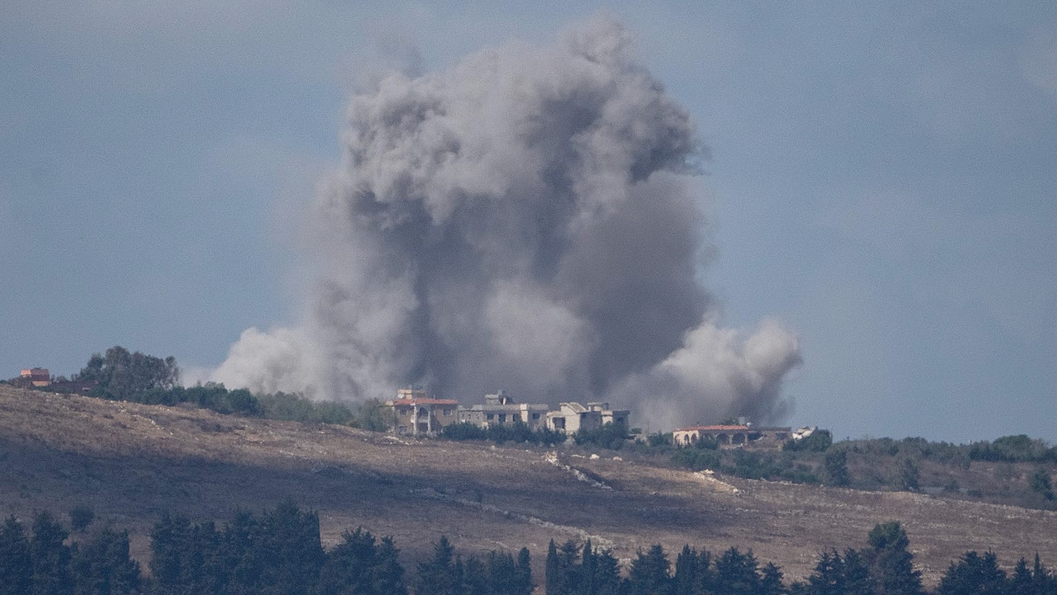 An Israeli airstrike hits an area in southern Lebanon as seen from northern Israel, 2 October 2024