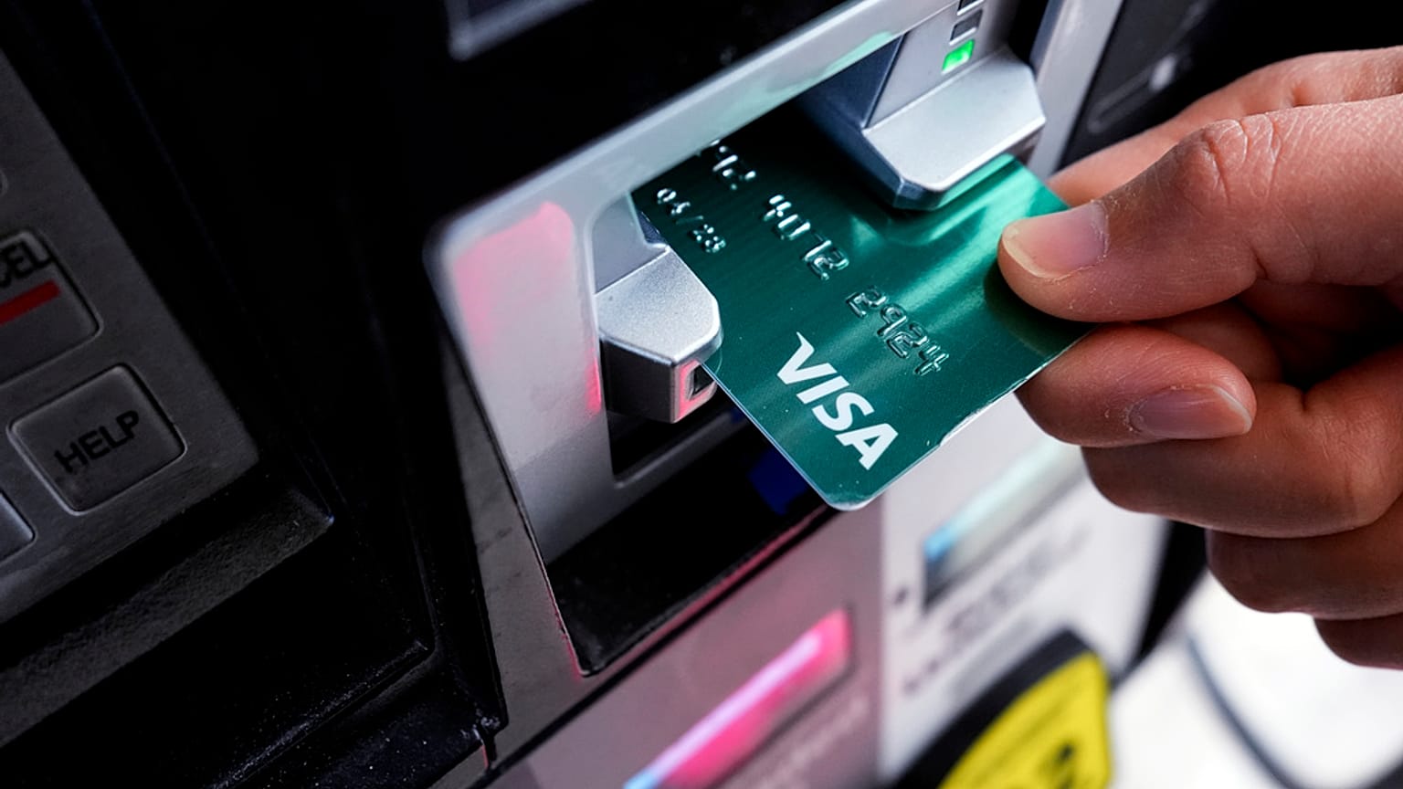 FILE - A customer uses a Visa credit card to pay for gasoline at a gas station in Mundelein, Ill., Feb. 8, 2024. 