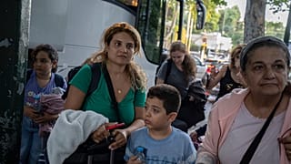 Griechische Staatsbürger, die mit einem griechischen Militärtransportflugzeug aus dem Libanon evakuiert wurden, stehen vor dem Gebäude des griechischen Außenministeriums in Athen, 3. Oktober 2024
