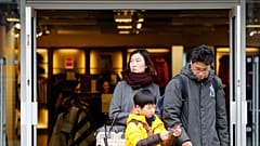 Library picture of overseas shoppers leaving a Burberry shop in central London