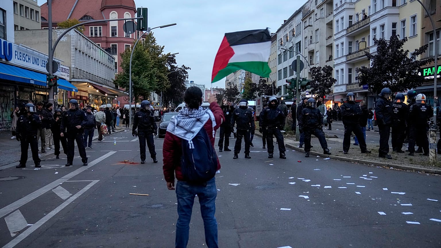 A protestor waves the Palestinian flag during a pro-Palestinian rally in Berlin, Germany, Sunday, Oct. 6, 2024.