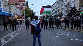 A protestor waves the Palestinian flag during a pro-Palestinian rally in Berlin, Germany, Sunday, Oct. 6, 2024.