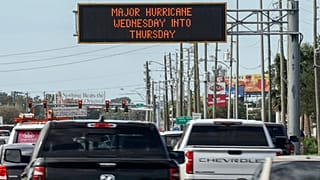 Highway signage announces the impending arrival of Hurricane Milton and the evacuations zones on Tuesday in Port Richey, Florida