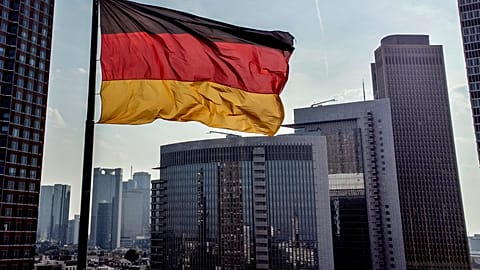 A German flag in front of the buildings of the banking district in Frankfurt 