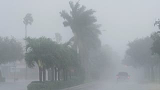 A Lee County Sheriff's officer patrols the streets of Cape Coral, Fla., as heavy rain falls ahead of Hurricane Milton