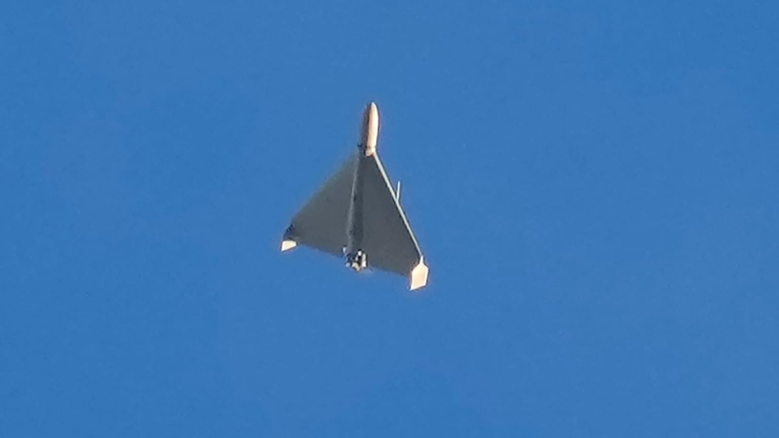 FILE - An Iranian Shahed exploding drone launched by Russia flies through the sky seconds before it struck buildings in Kyiv, Ukraine, on Oct. 17, 2022
