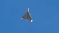 FILE - An Iranian Shahed exploding drone launched by Russia flies through the sky seconds before it struck buildings in Kyiv, Ukraine, on Oct. 17, 2022
