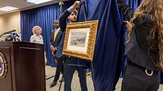 FBI agents unveil a Claude Monet painting to its original owners' descendants at the New Orleans office on Wednesday, 9 October 2024.