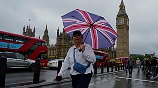 A woman walks past the Houses of Parliament in London