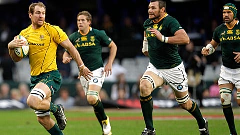 FILE - Australia's captain Rocky Elsom runs with ball as South Africa's players chase him at the Tri-Nations Test match in Durban, South Africa, on 13 August, 2011. 