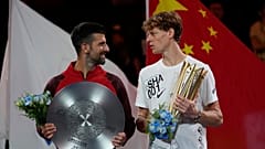 Jannik Sinner right, chats with Novak Djokovic.