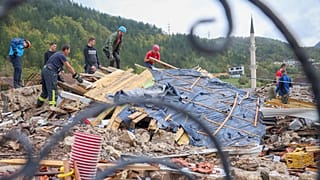 Rescuers search for missing people after floods and landslides in the village of Donja Jablanica, 5 October 2024