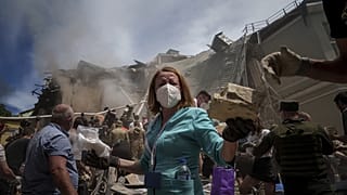 Emergency workers remove rubble and look for survivors at the site of Okhmatdyt children's hospital hit by Russian missiles, in Kyiv, Ukraine, 8 July 2024.