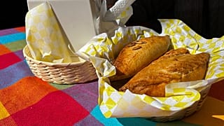A basket of Mexican pastes sit on a patron's table before they are eated for lunch at the 16th International Paste Festival in Mineral del Monte