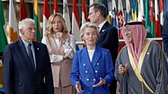 Participants speak during a group photo at an EU-Gulf Cooperation Council meeting in Brussels, 16 October 2024