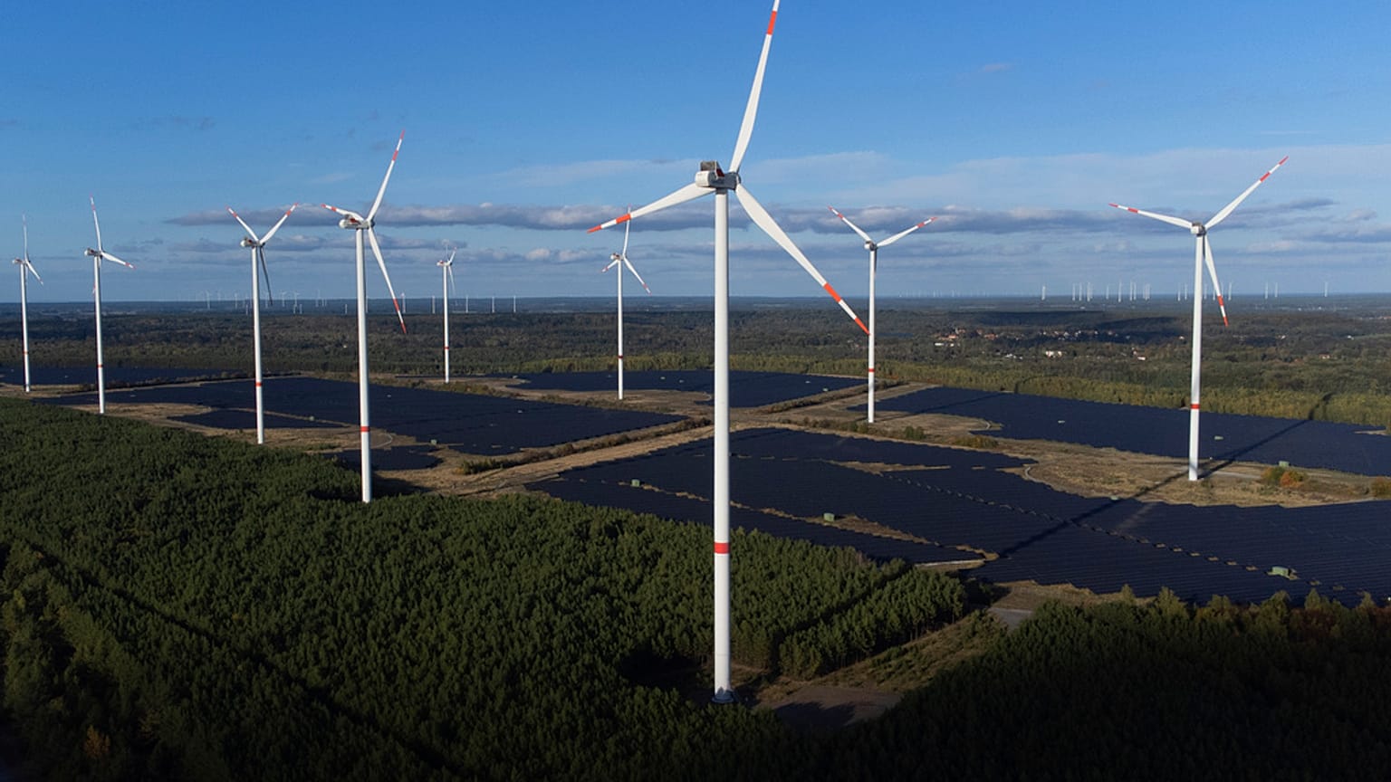 Wind turbines operate at the Klettwitz Nord solar energy park near Klettwitz, Germany on Tuesday