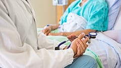 A doctor discusses with a hospital patient.