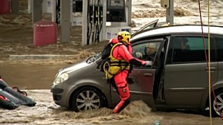 Firefighter rescues people from car trapped in water, Givors, France, 17 October 2024