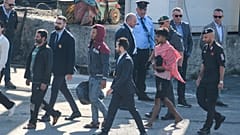 Migrant and security officials walk at the port of Shengjin, northwestern Albania. Wednesday, Oct. 16, 2024 